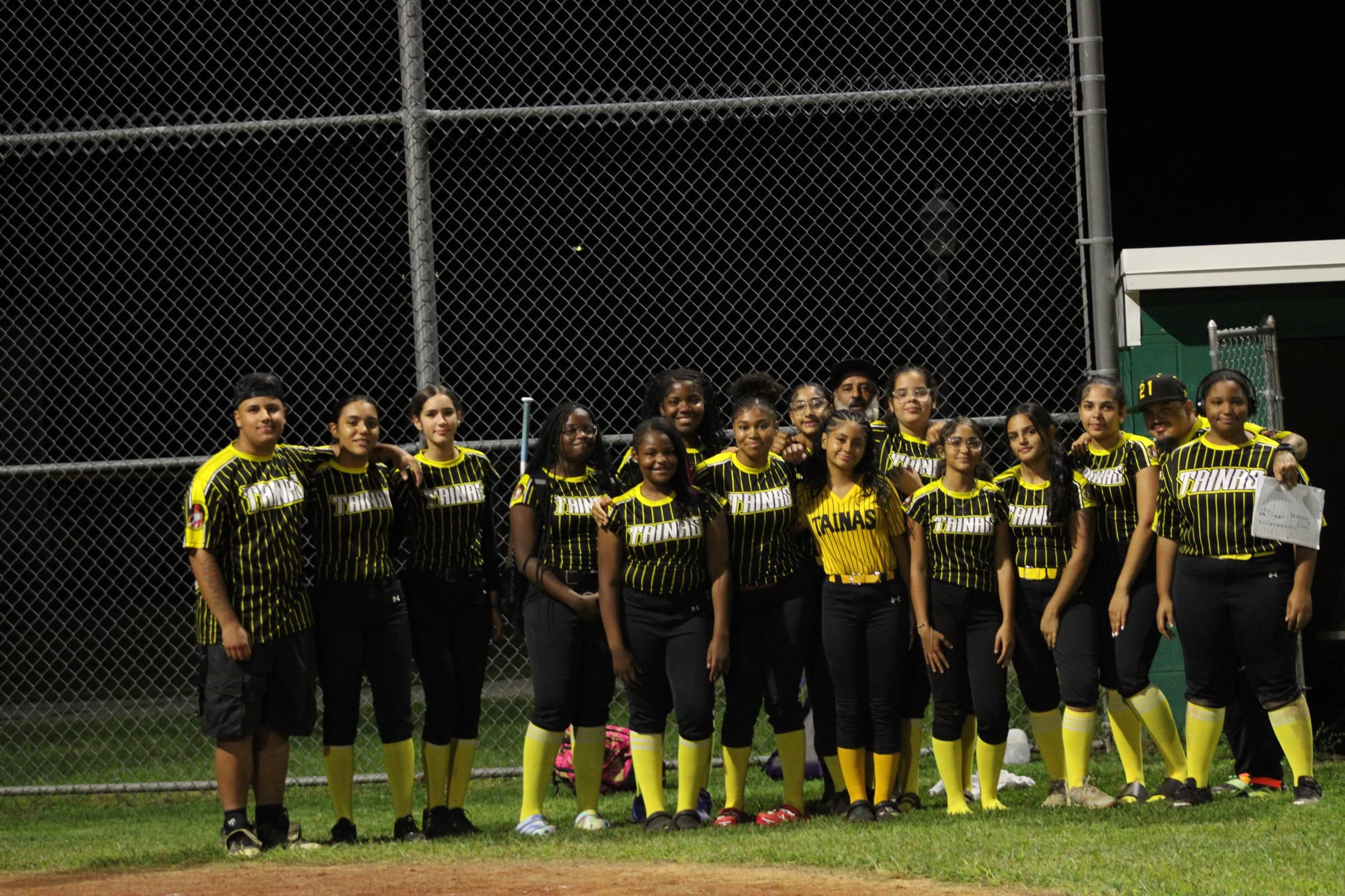 Tainas softball players and coaches together after a game
